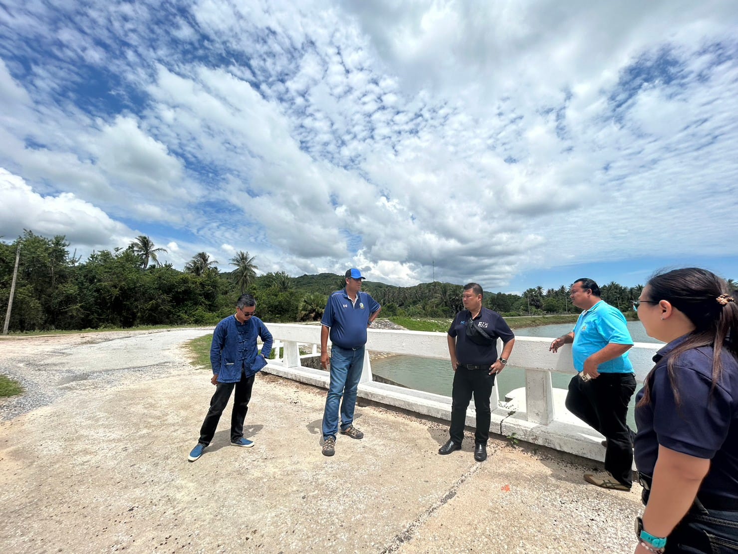 A group of men standing on a bridge

Description automatically generated