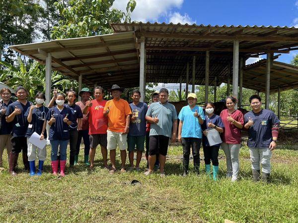 A group of people standing in front of a shelter

Description automatically generated