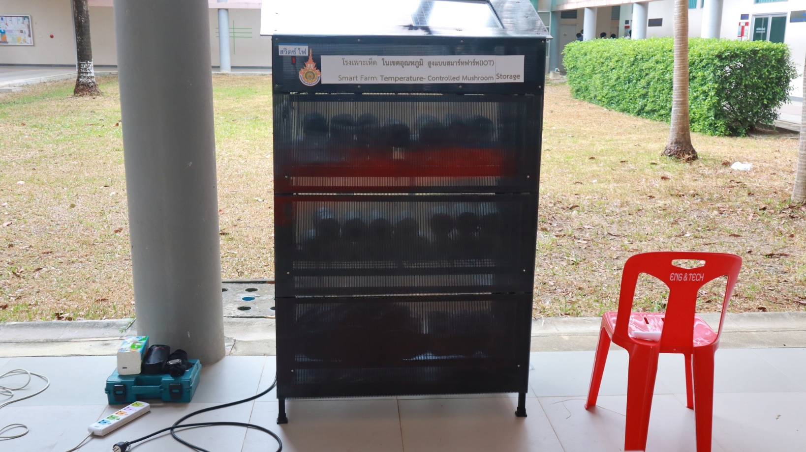 A black metal cabinet with a red chair

AI-generated content may be incorrect.