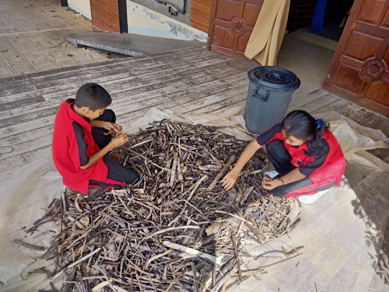 A group of kids sitting on a pile of sticks

AI-generated content may be incorrect.