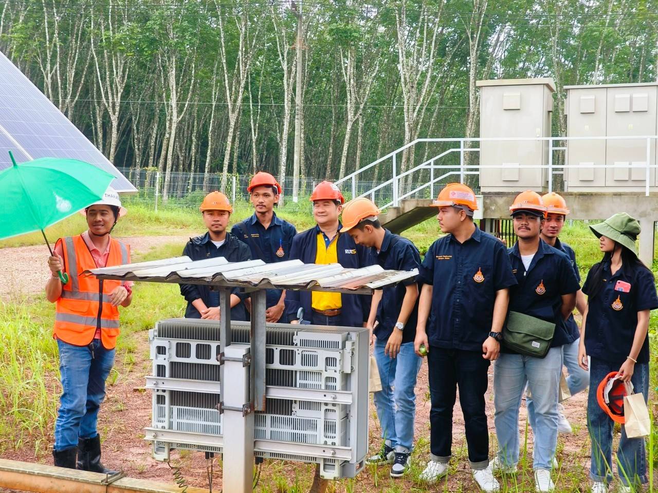 A group of men in hard hats standing next to a metal structure AI-generated content may be incorrect.