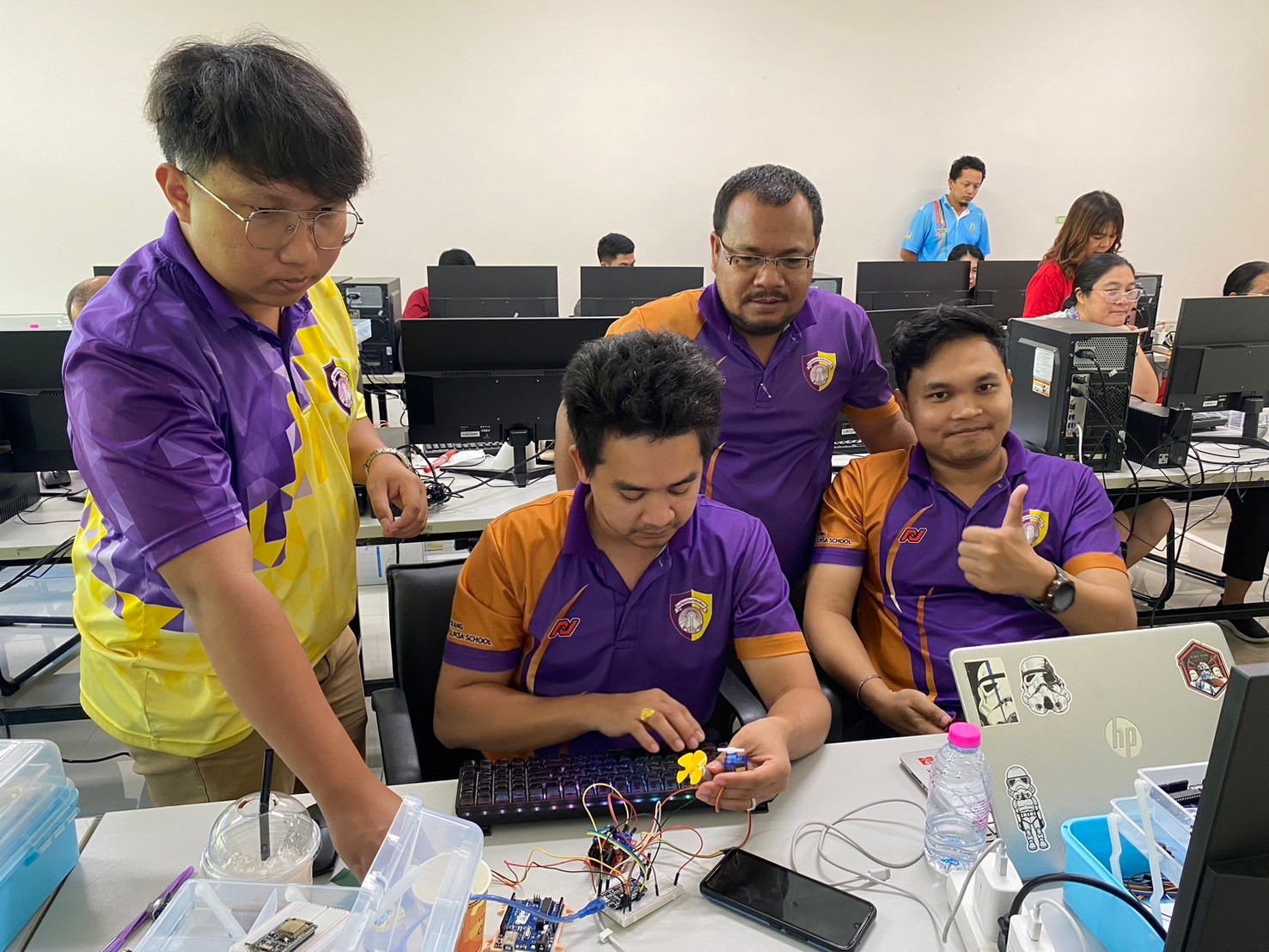 A group of men in purple shirts

AI-generated content may be incorrect.