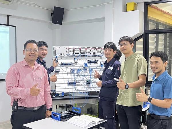 A group of men standing in front of a board with wires
AI-generated content may be incorrect.
