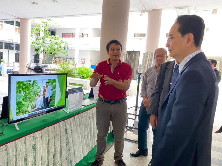 A group of men standing in front of a computer screen

AI-generated content may be incorrect.