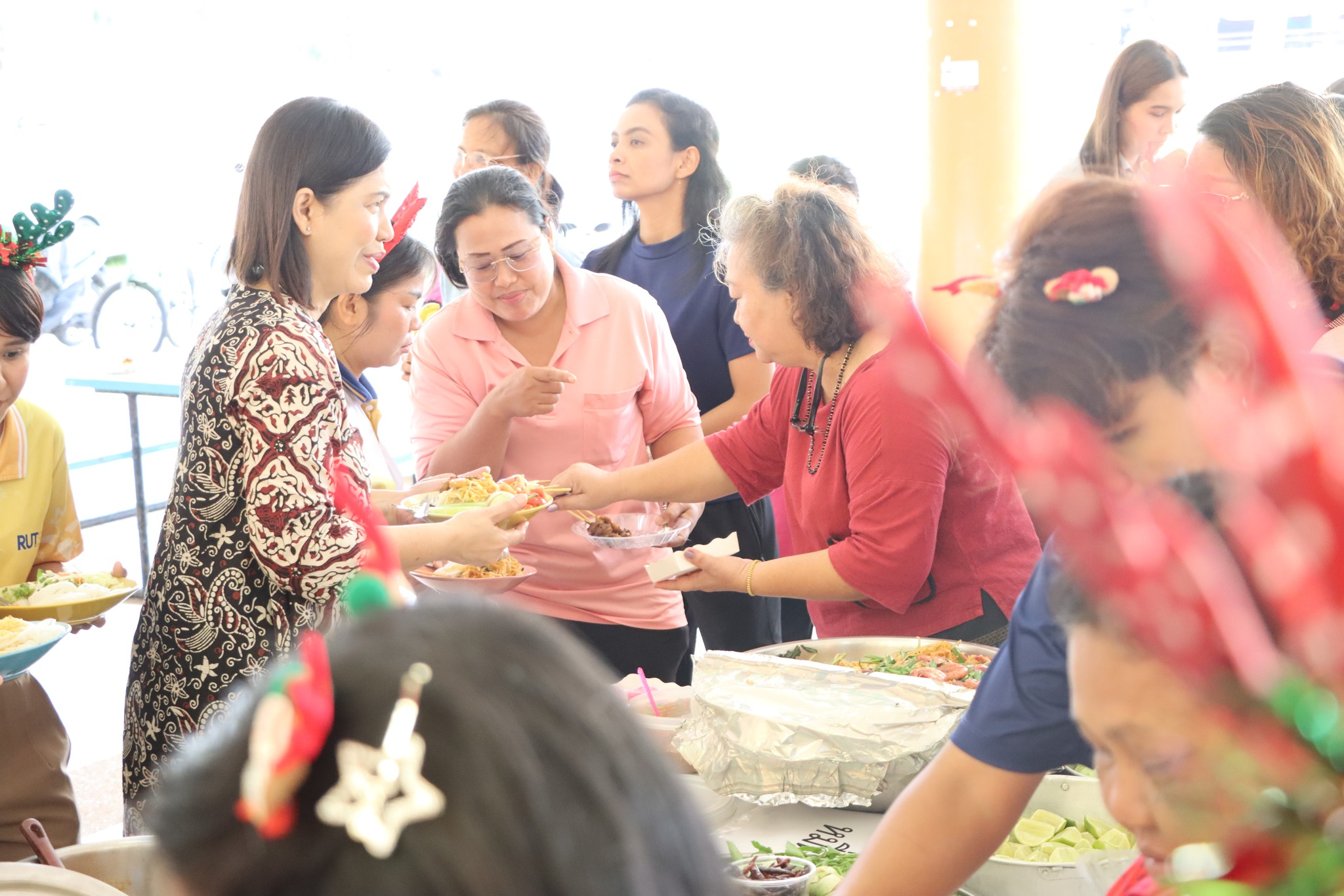 A group of people serving food
AI-generated content may be incorrect.