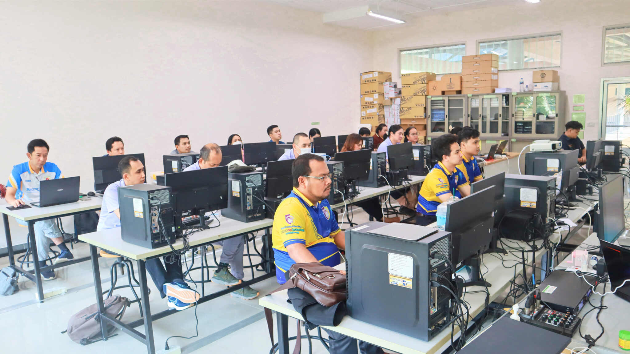 A group of people sitting at computers

AI-generated content may be incorrect.