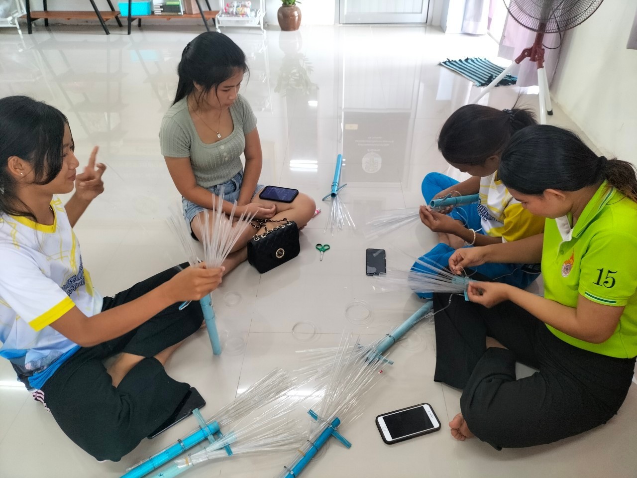 A group of people sitting on the floor

AI-generated content may be incorrect.