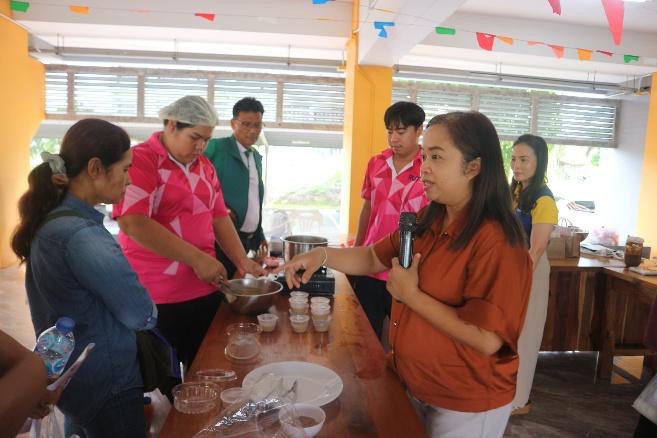 A group of people standing around a table
AI-generated content may be incorrect.