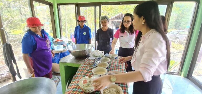 A group of people standing around a table AI-generated content may be incorrect.