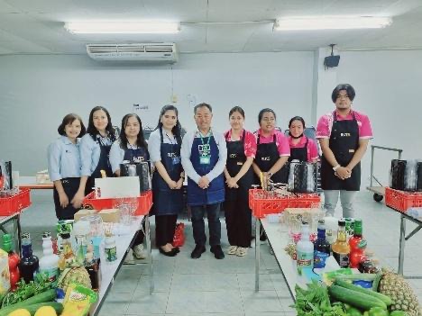 A group of people standing in a kitchen AI-generated content may be incorrect.