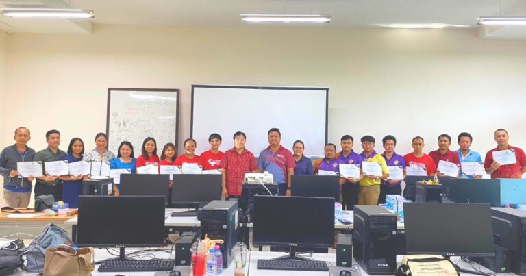 A group of people standing in front of computers AI-generated content may be incorrect.