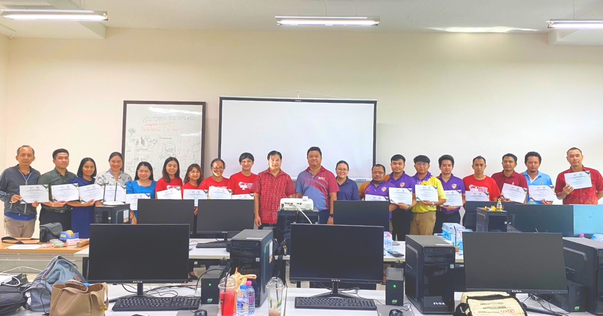 A group of people standing in front of computers AI-generated content may be incorrect.