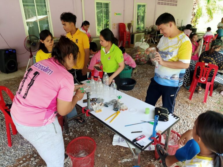 A group of people working on a table AI-generated content may be incorrect.