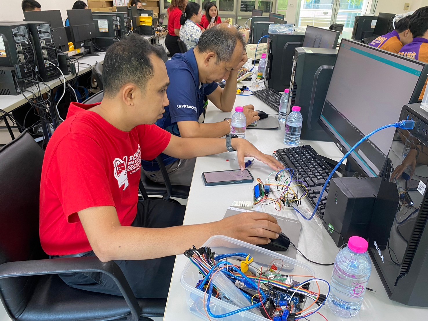 A group of people working on computers

AI-generated content may be incorrect.