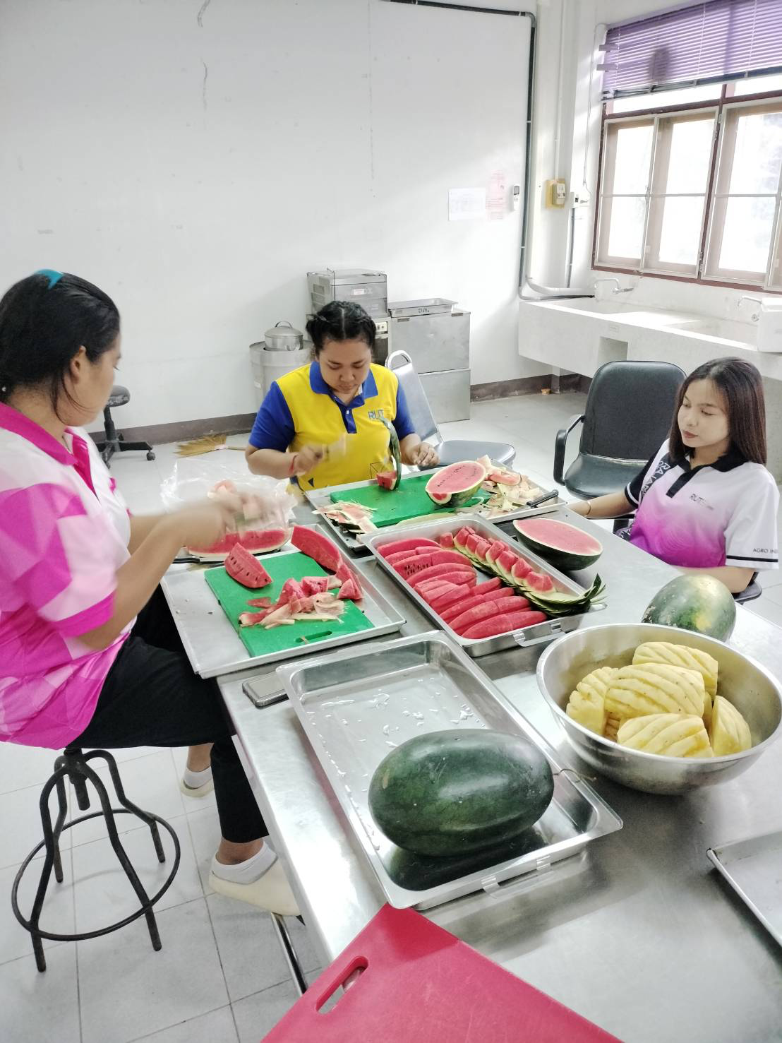 A group of women sitting at a table with fruit
AI-generated content may be incorrect.