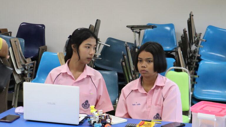 A pair of young women sitting at a table

AI-generated content may be incorrect.