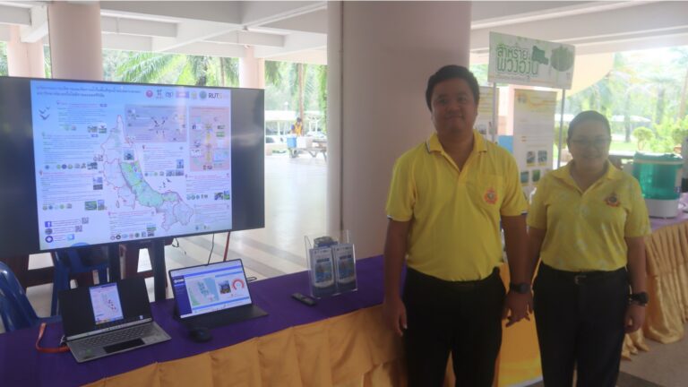 A person standing next to a table with a display AI-generated content may be incorrect.