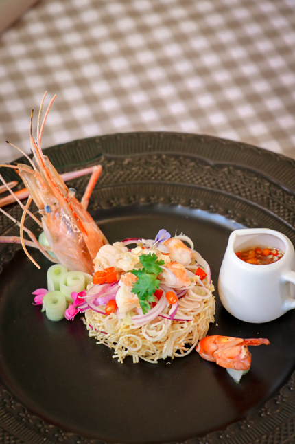 A plate of food with shrimp and sauce
AI-generated content may be incorrect.