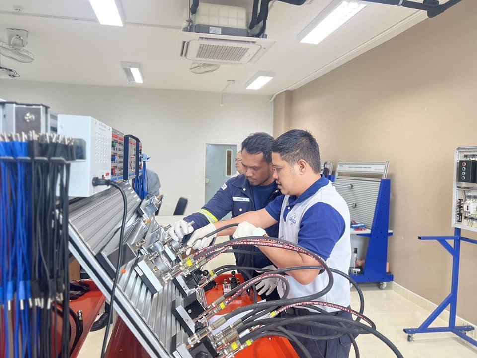 Men working on a machine
AI-generated content may be incorrect.