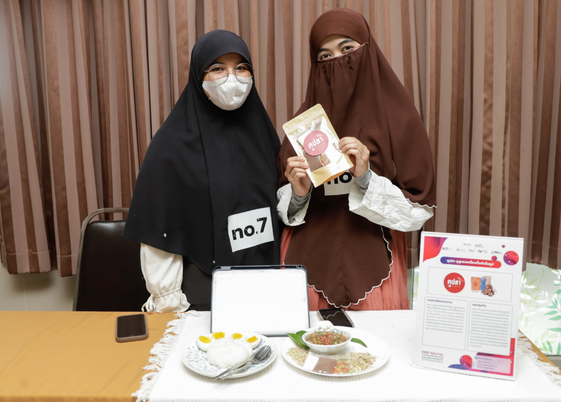 Two women wearing face masks and holding a package
AI-generated content may be incorrect.
